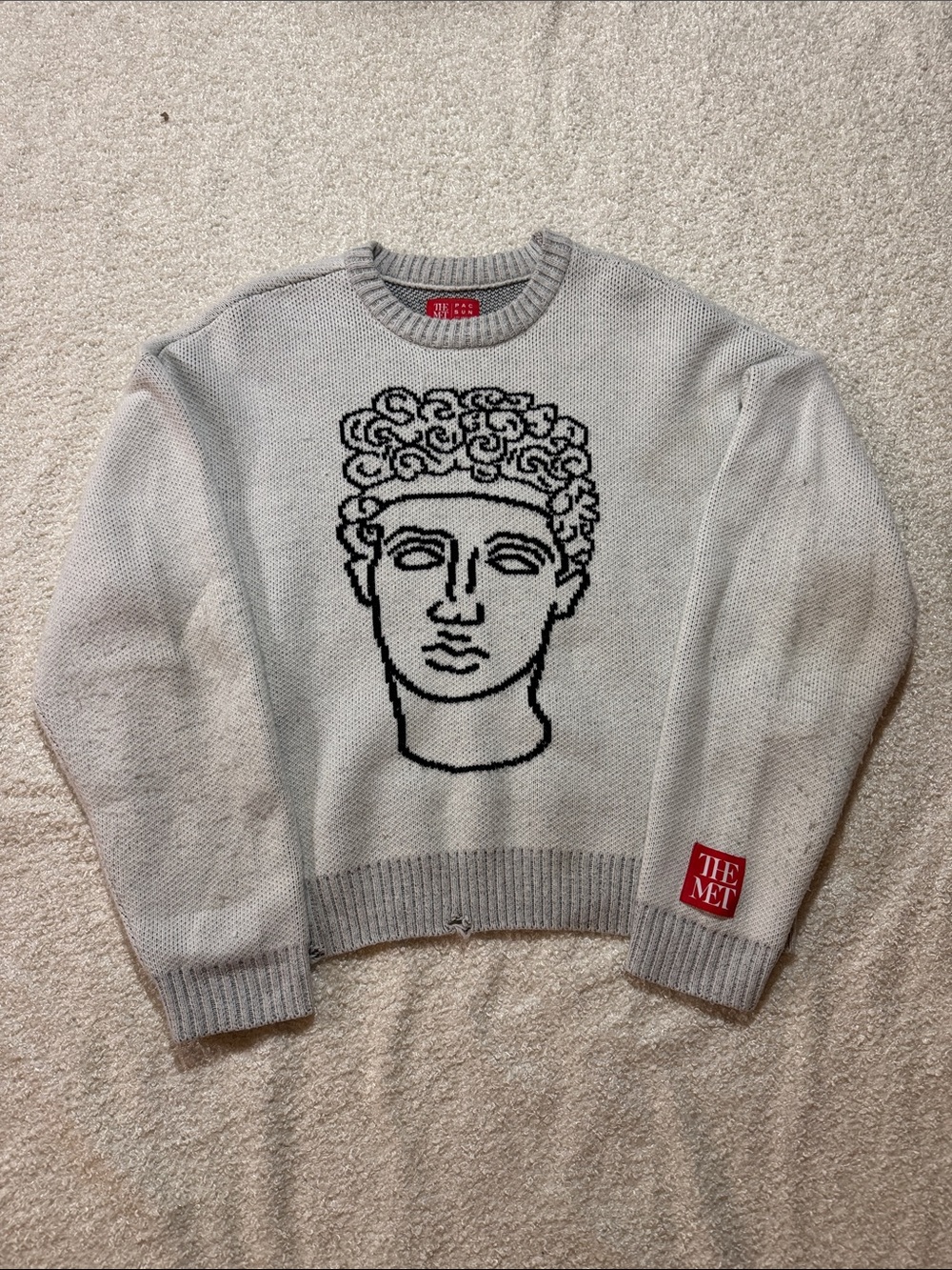 PacSun Light Gray Crewneck Sweater with Black Sculpted Face Motif and Red Patch